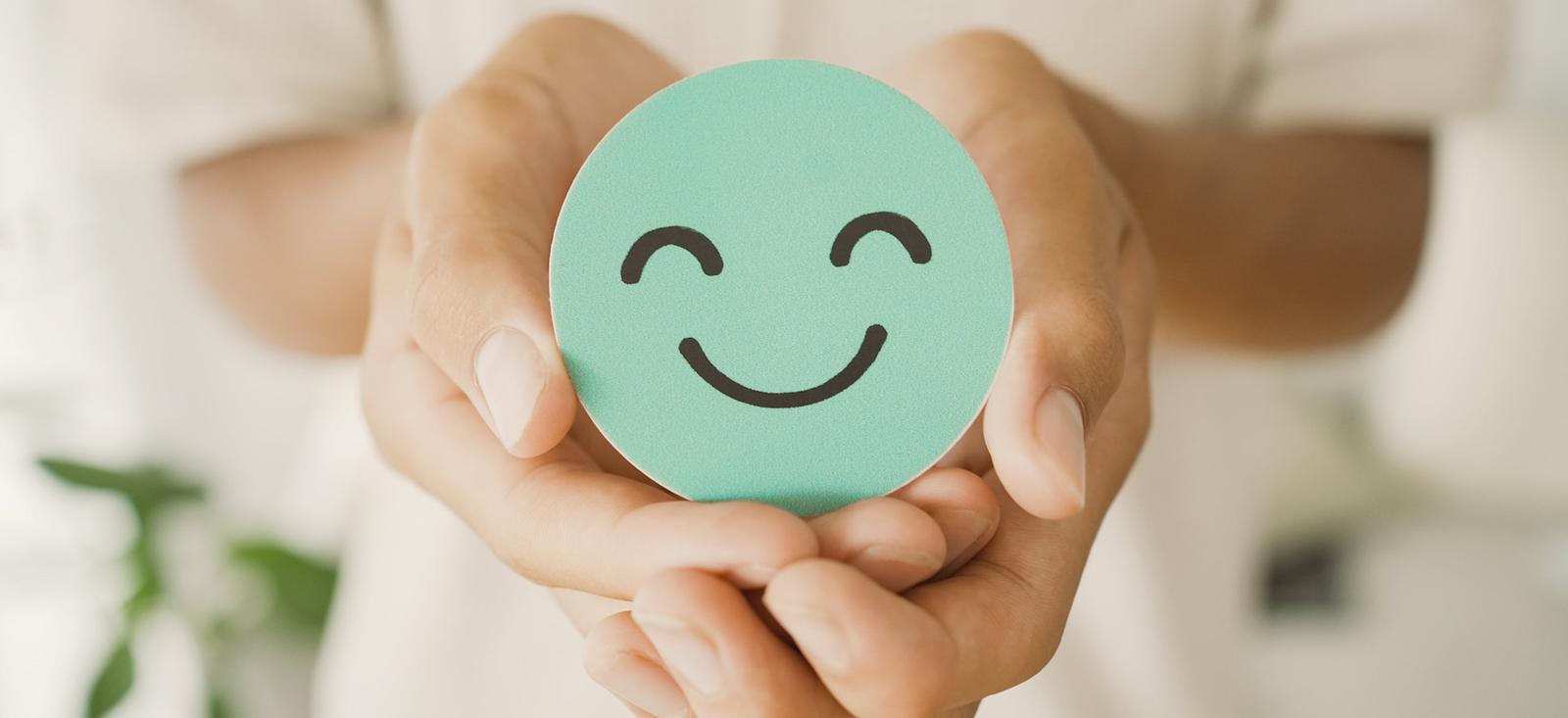 A cardboard cutout of a smiley face.