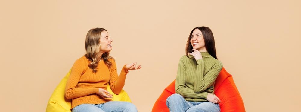 Photo of two women on beanbags talking